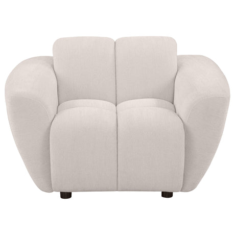 Side angle of Destino chenille accent chair showing tufted upholstery and wooden legs