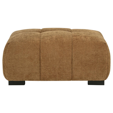 Octavia ottoman side view showing amber fabric and wood legs