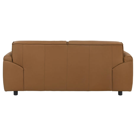 Side profile of orange leather loveseat with plastic legs