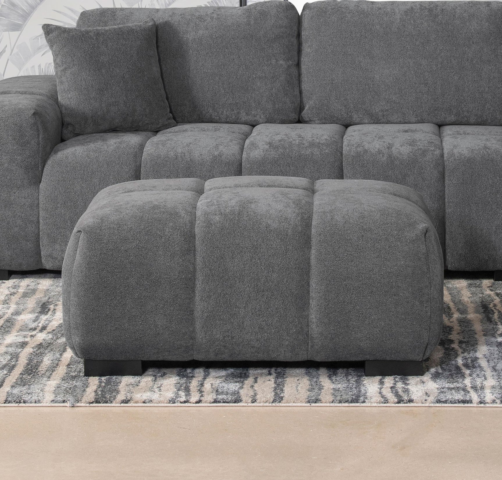 Octavia Rectangular Ottoman angled side view showing tufted upholstery