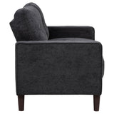 Close detail of loveseat fabric and arm design in steel grey