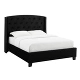 Close-up of tufted black velvet upholstery on headboard