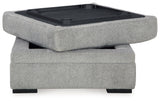 Ottoman top flipped up revealing cup holders