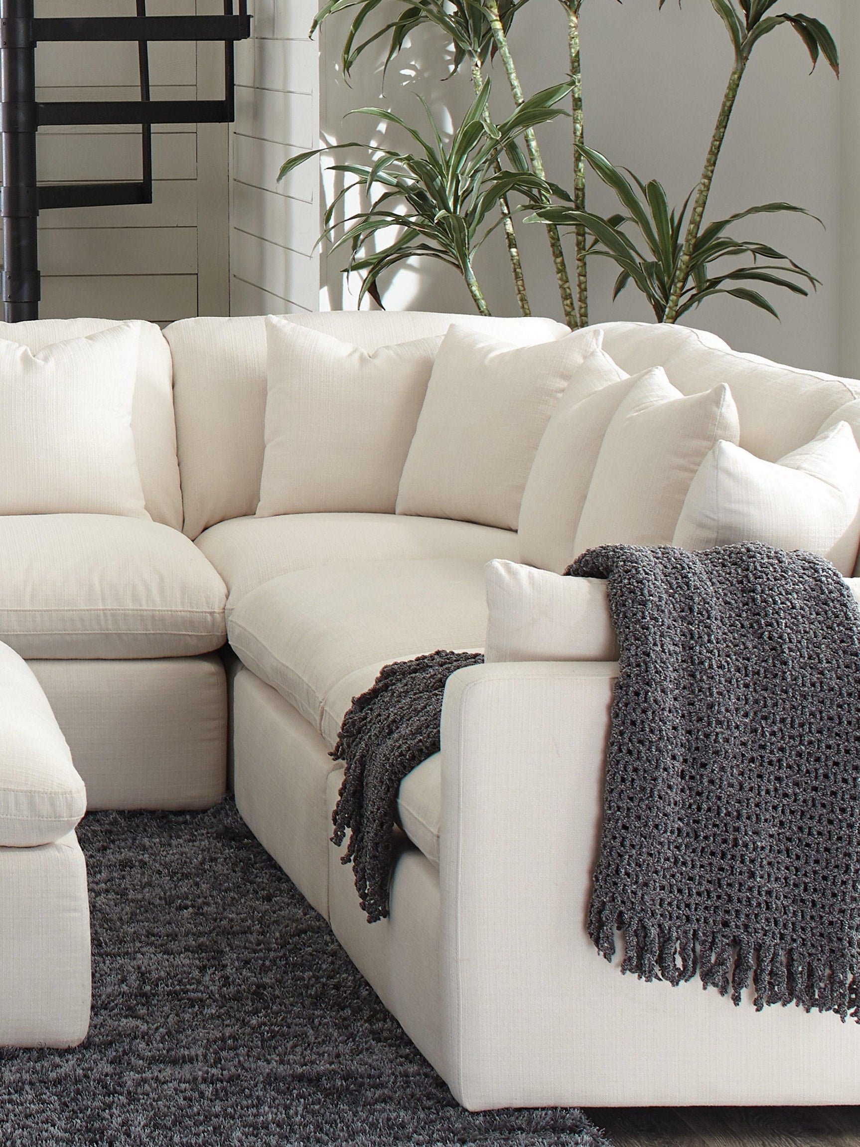 Front view of Hobson ottoman highlighting tufted seat and stitching