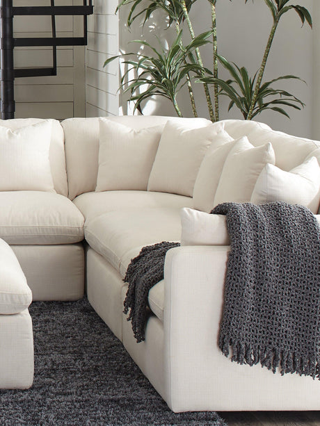 Front view of Hobson ottoman highlighting tufted seat and stitching