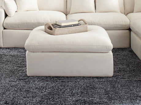 Hobson off-white upholstered ottoman with tufted cushion seat, angled front view