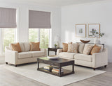 Back angle of Christine beige loveseat highlighting tapered legs and fabric texture