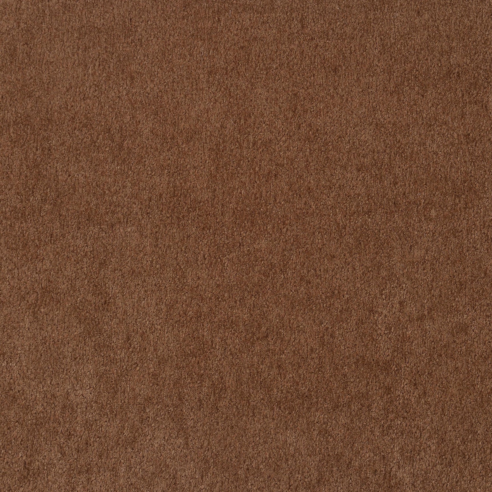 Detailed view of sofa cushions in rust velvet