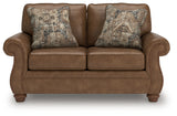 Chasemore Loveseat side angle showing turned legs and plush cushions