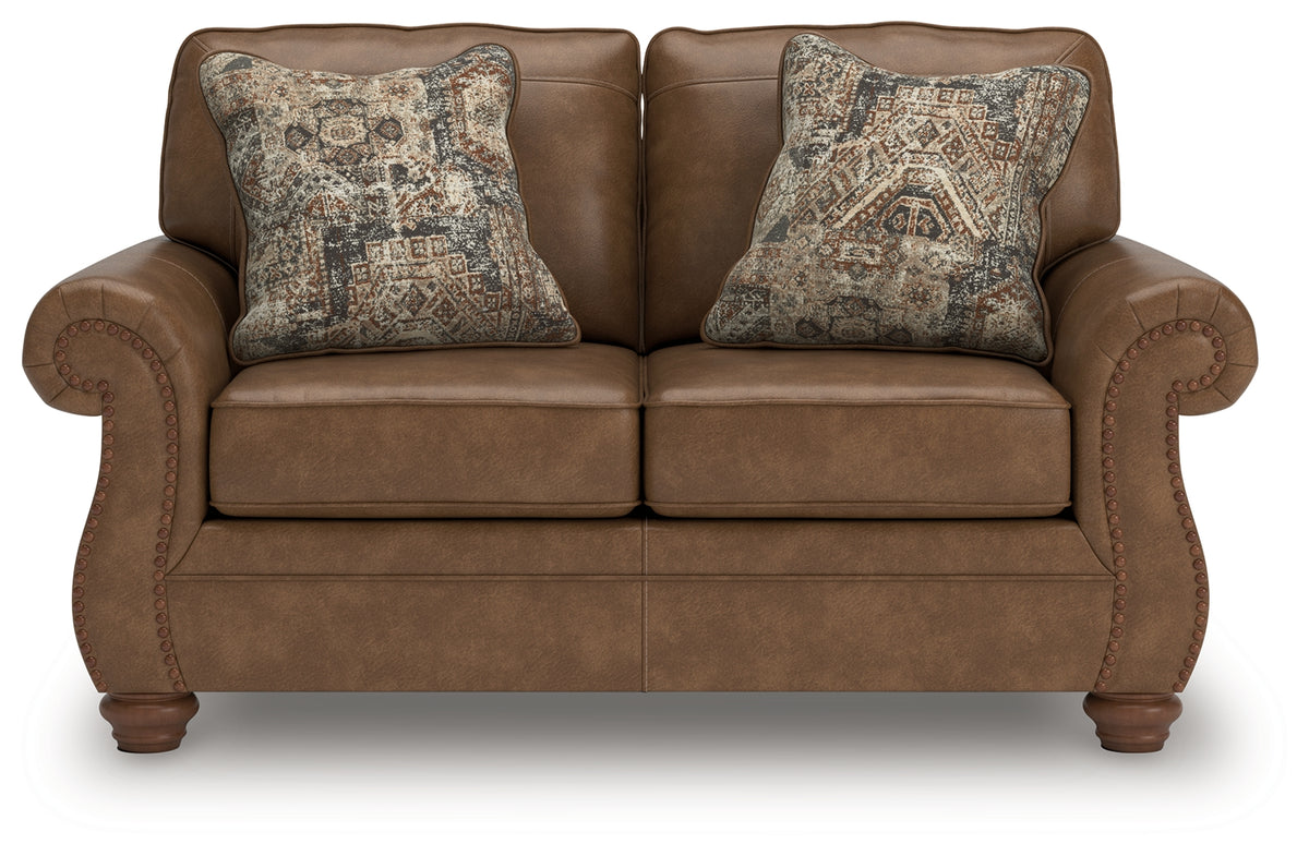 Chasemore Loveseat side angle showing turned legs and plush cushions