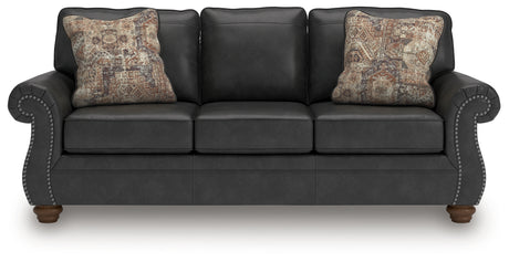 Close-up of jumbo stitching and accent nails on sofa upholstery