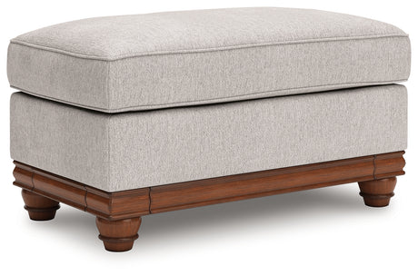 Clearbrooke Ottoman angled view showing chenille fabric and decorative legs