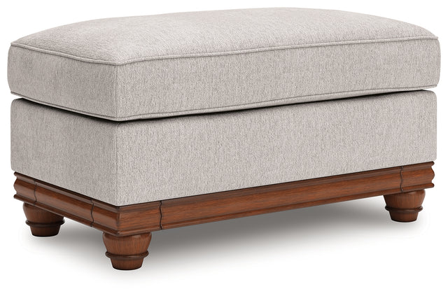 Clearbrooke Ottoman angled view showing chenille fabric and decorative legs