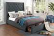 Open drawer in footboard showing storage space of Fairborn gray bed