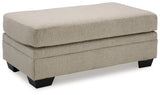 Stonemeade Ottoman side view showing faux wood finish feet