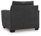 Side view of Loreo chair highlighting arm height and fabric texture