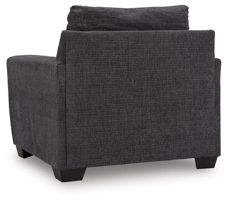 Side view of Loreo chair highlighting arm height and fabric texture