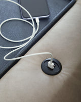 USB charging ports and stitching close-up on armrest