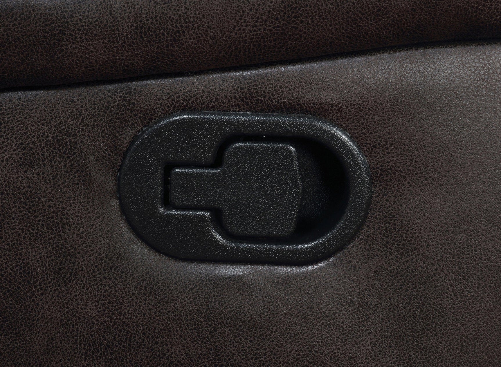 Close-up of tufted upholstery and padded armrest