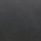 Close-up of faux leather texture and stitching on Status Check Shadow recliner