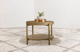 Side view of Arini Round End Side Table showcasing woven rattan shelf and metal legs