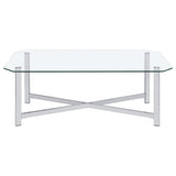 End table positioned beside sofa with glass top and chrome frame