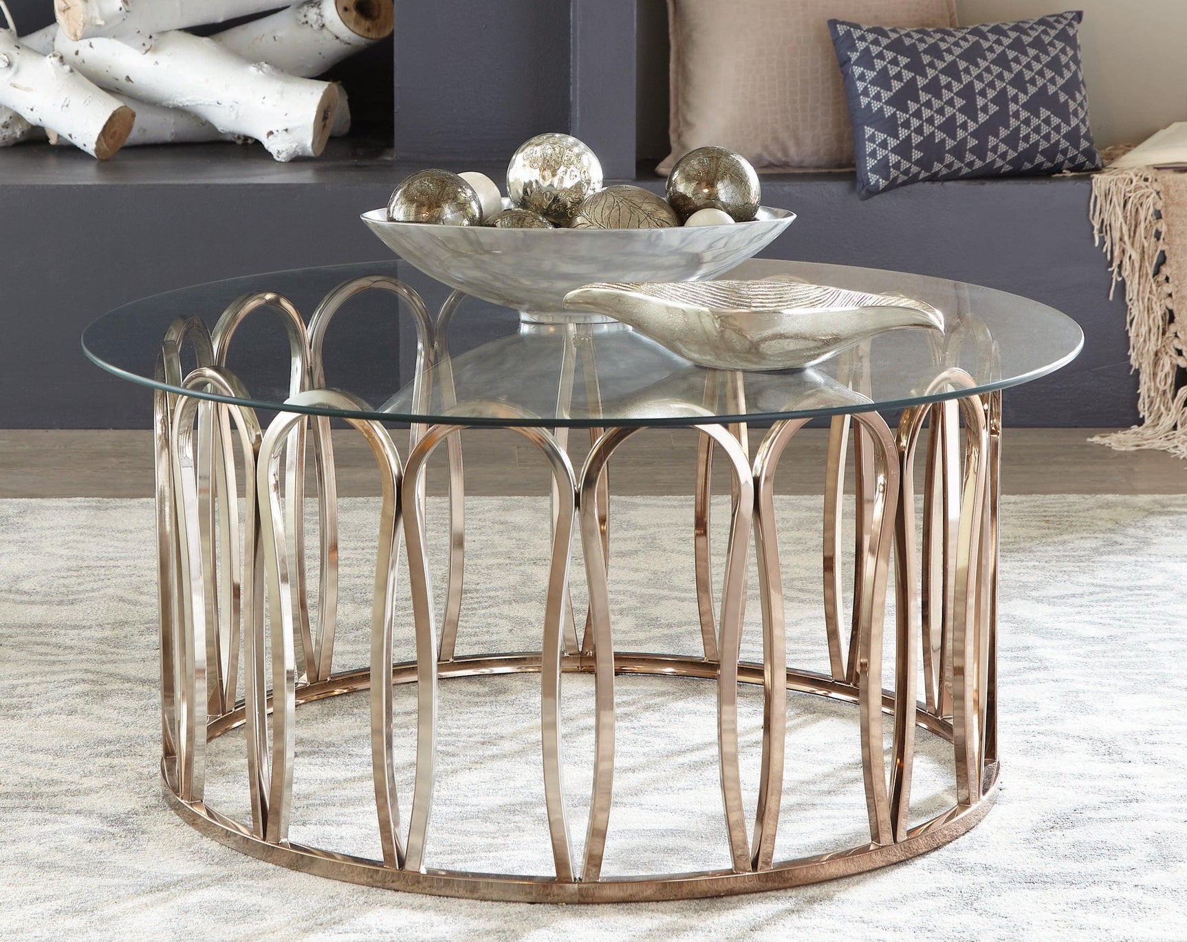 Monett Round Coffee Table artistic curved metal base with glass top side view