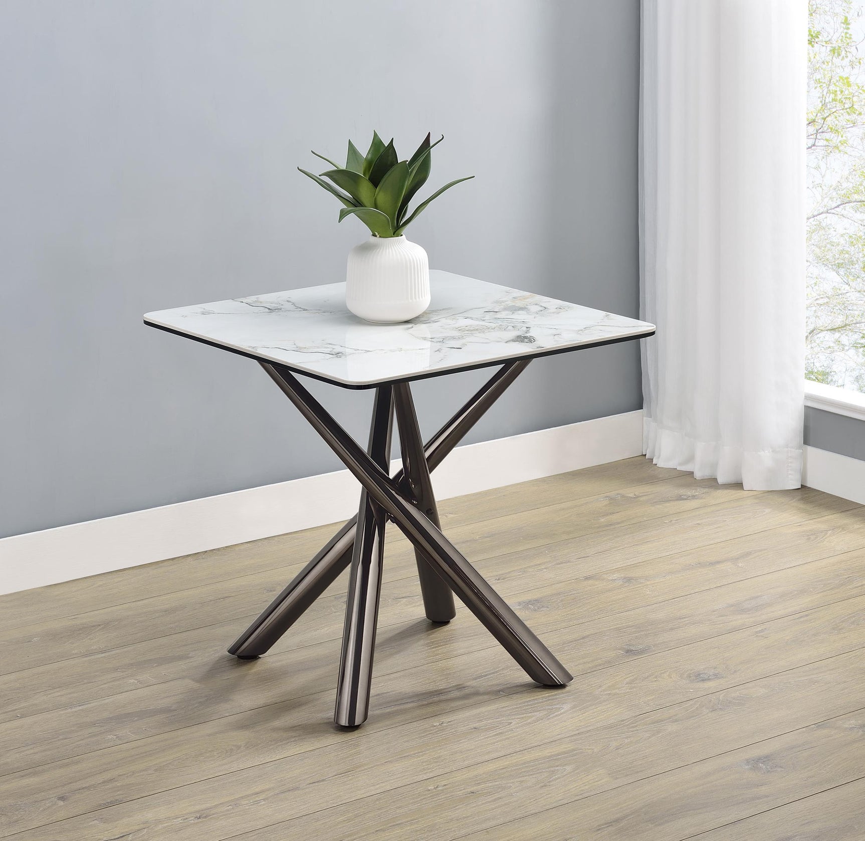 Close-up of sintered stone and black tempered glass layers on Carvell end table