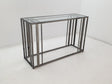 Adri rectangular sofa table side view showing glass top and black nickel frame