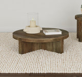 Side view of Kinkaid round mango wood coffee table showing leg design