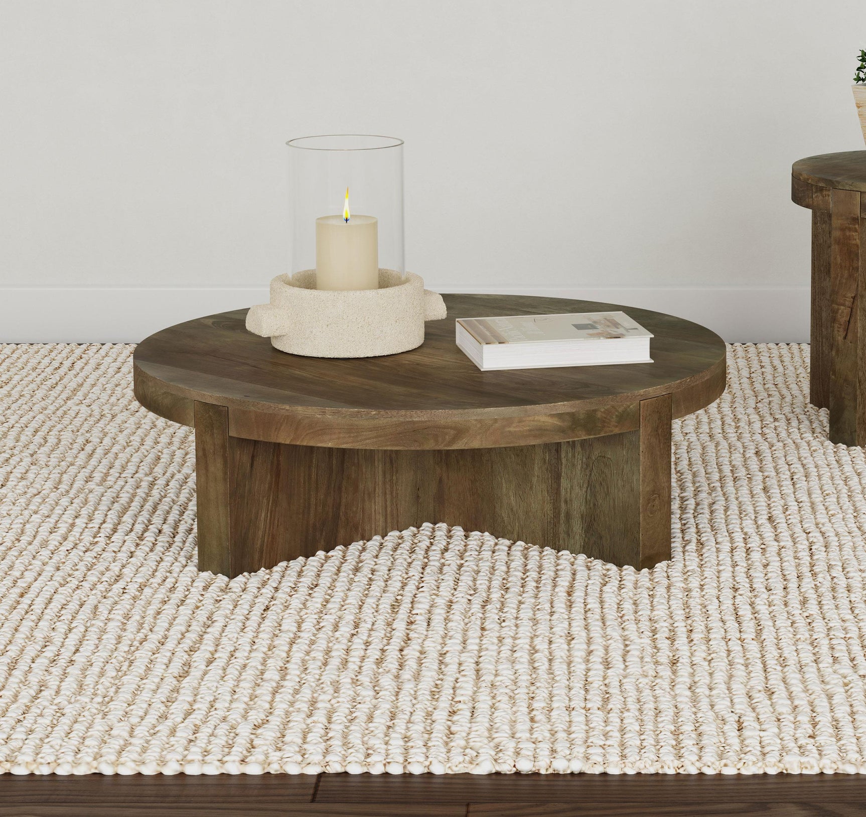 Side view of Kinkaid round mango wood coffee table showing leg design