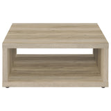 End table with decor and books on lower shelf
