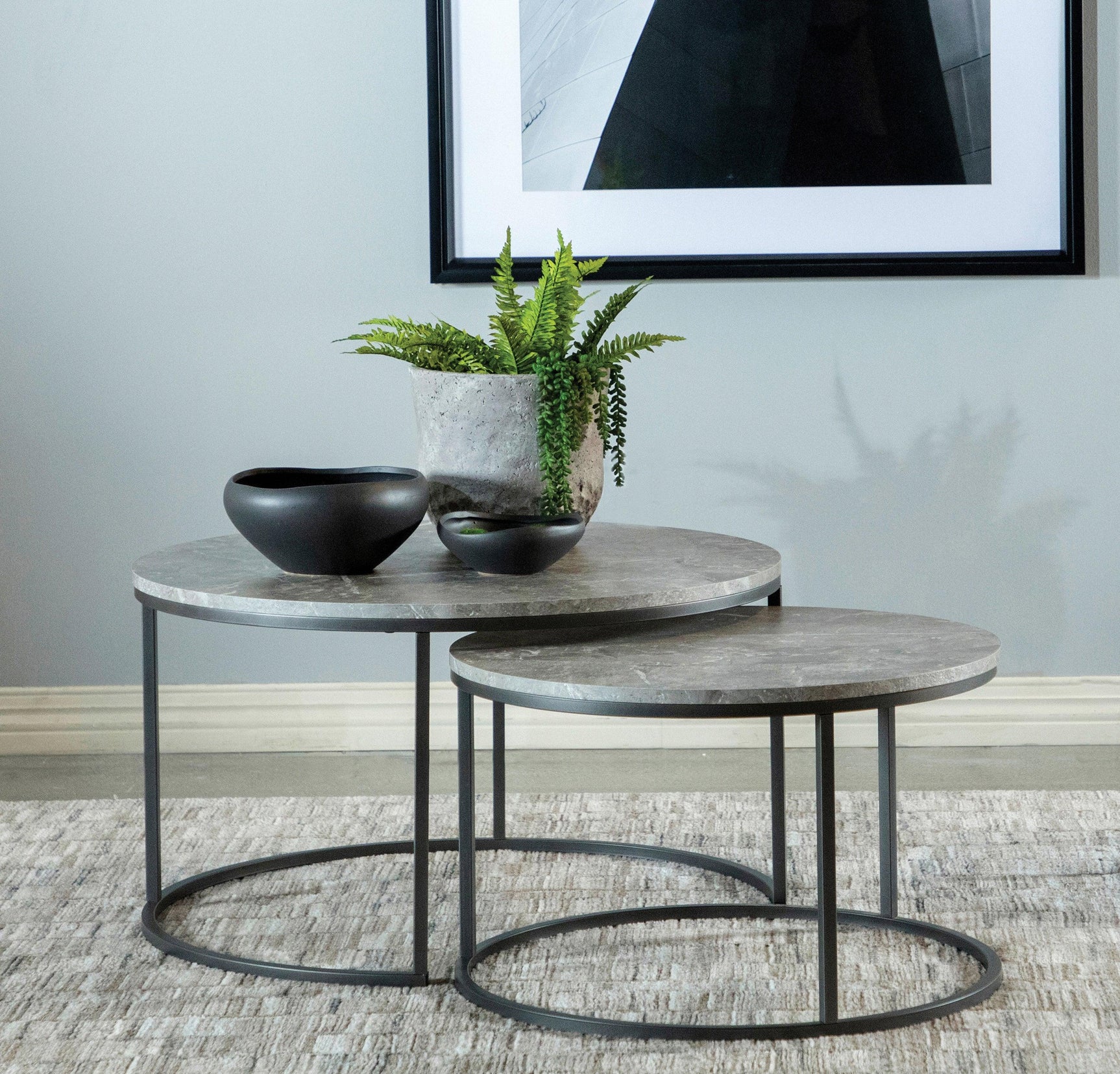 Small matching grey round coffee table nested under large table