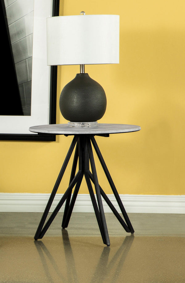 Side view of Hadi round end table showing hairpin legs and cement tabletop