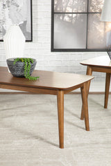 Close-up of Radley natural walnut coffee table flared legs and chamfered edges