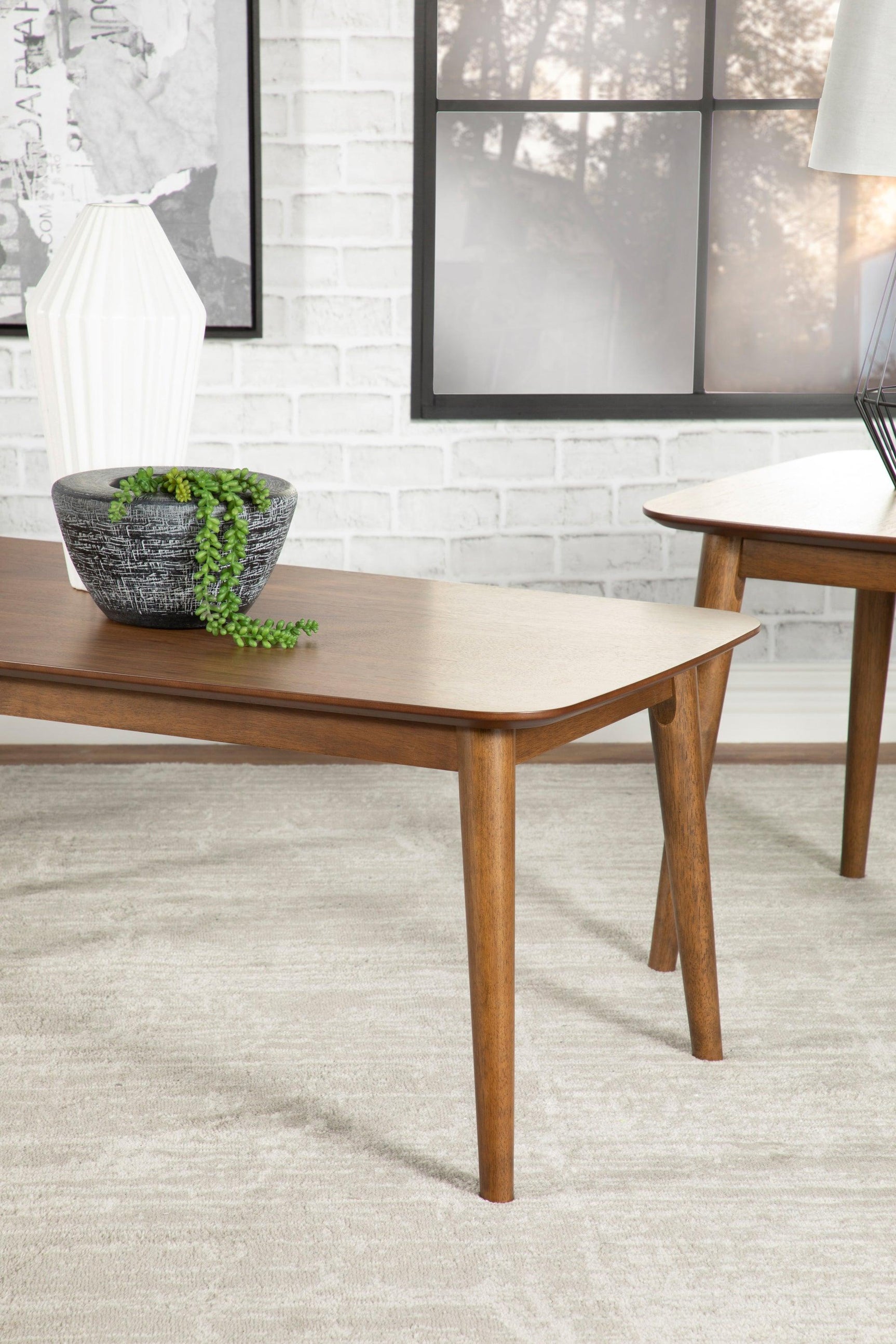 Close-up of Radley natural walnut coffee table flared legs and chamfered edges