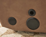 Speaker detail on Lorrenton caramel faux leather power glider recliner
