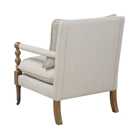 Angled view of Monaghan upholstered accent chair highlighting wood frame and casters