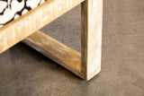 Close-up of black mango wood frame and fabric upholstery on bench