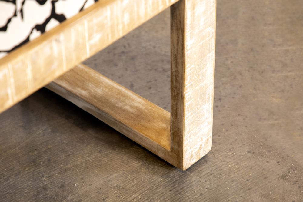 Close-up of black mango wood frame and fabric upholstery on bench