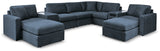 living room setup with sectional sofa and ottoman