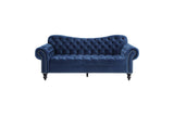 detail view of tufted navy velvet upholstery on sofa