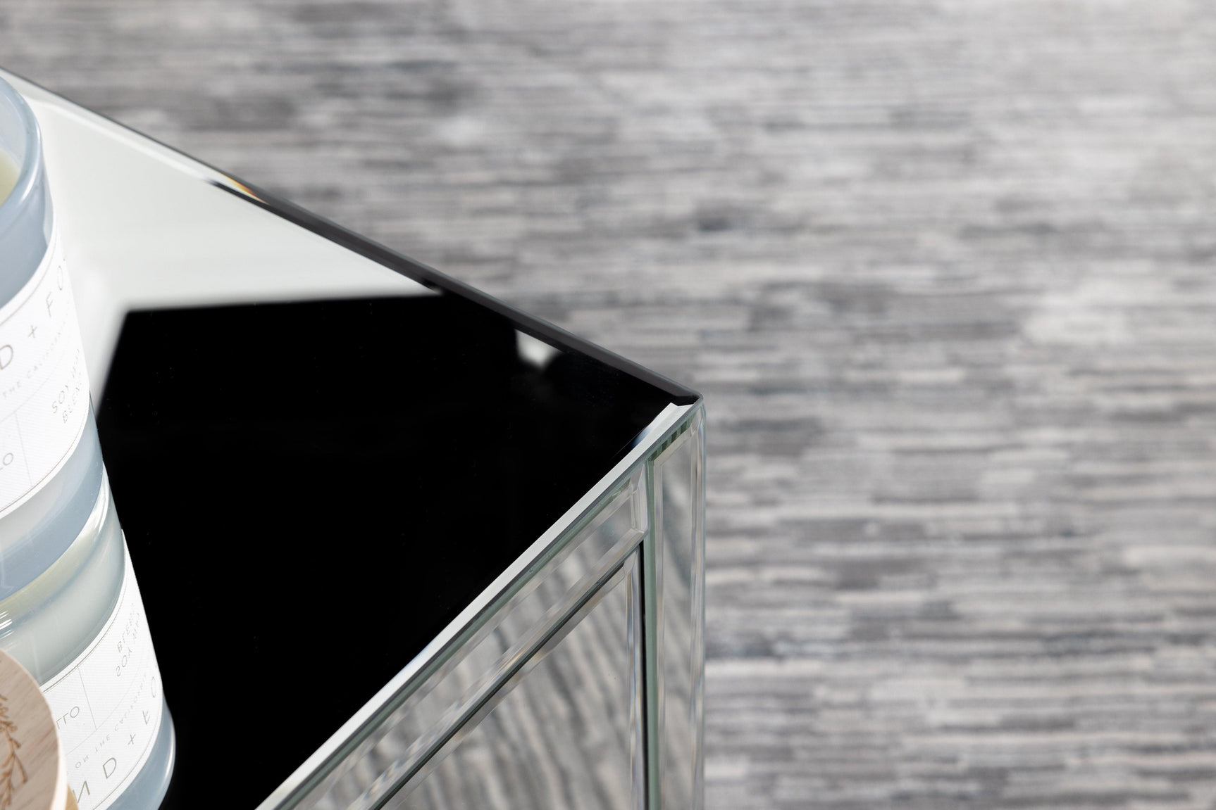 Coquette mirrored accent table styled with decor on shelves