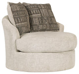 Side angle of Soletren Stone Chenille Swivel Accent Chair showing tufted back and rolled arms