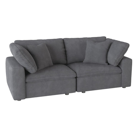 Side angle of gray microfiber upholstered love seat with pillows