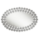 Oval mirror reflecting light with silver frame