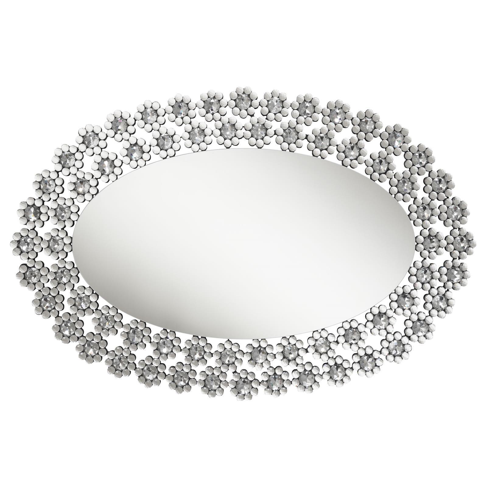 Oval mirror reflecting light with silver frame