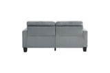 Angle view of gray tufted sofa cushions