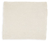 Close-up of hand-knitted texture on ivory throw