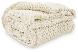 Set of three Chaddon Ivory Throws folded on bench